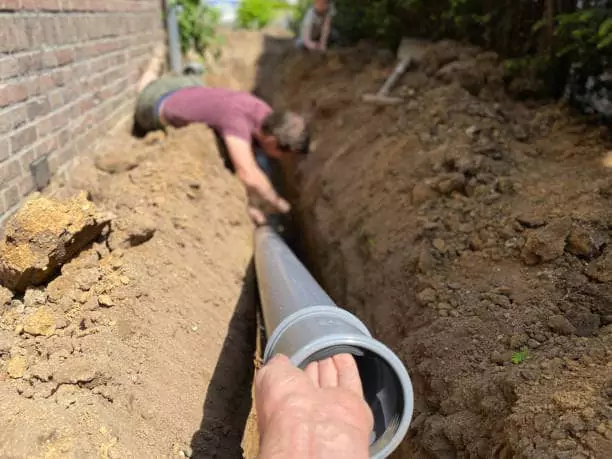 Pearce Scapes team installing drainage system