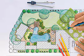 Pearce Scape team drawing landscape designs with pencil and paper