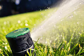 A sprinkler system watering in a landscape