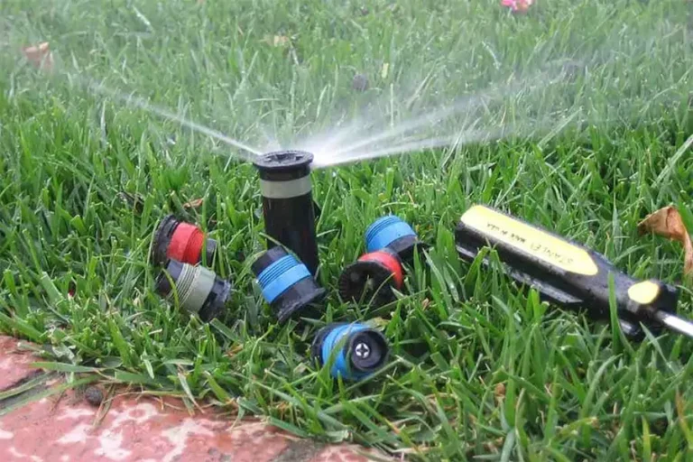 Watering in a green lawn with sprinkler system