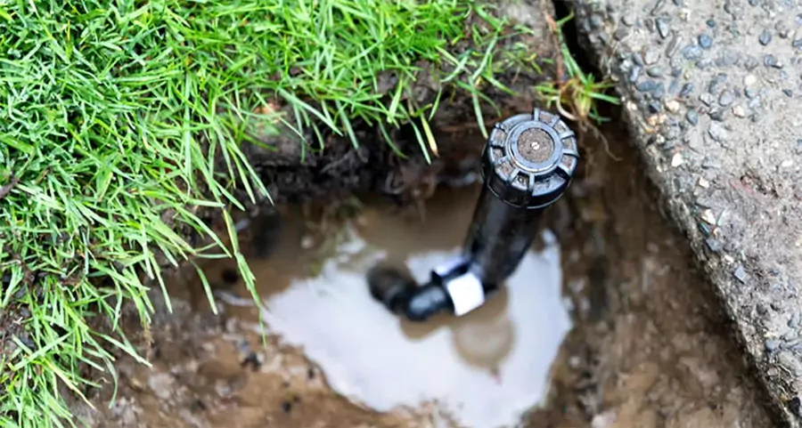 Need sprinkler system repair in a green lawn