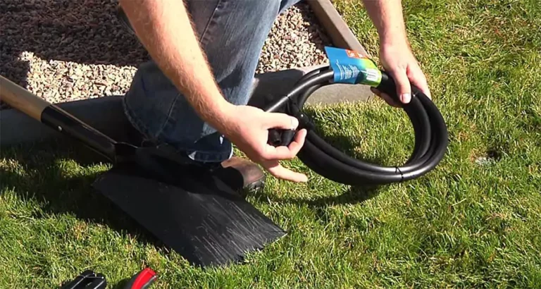 Person preparing to install drip irrigation tubing with shovel and tools—demonstrating a DIY approach to setting up efficient lawn watering systems in Indianapolis, IN.